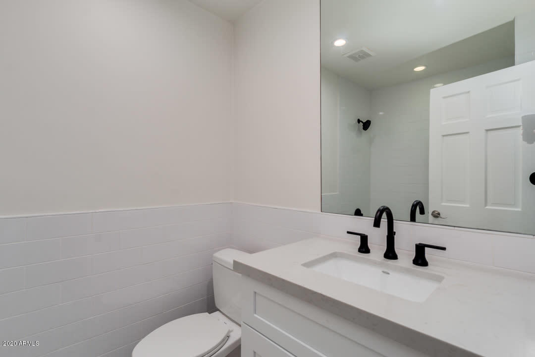 7475 East Raintree Court Scottsdale, AZ 85258 - Photo 27 of 38 a bathroom with a sink a toilet and mirror