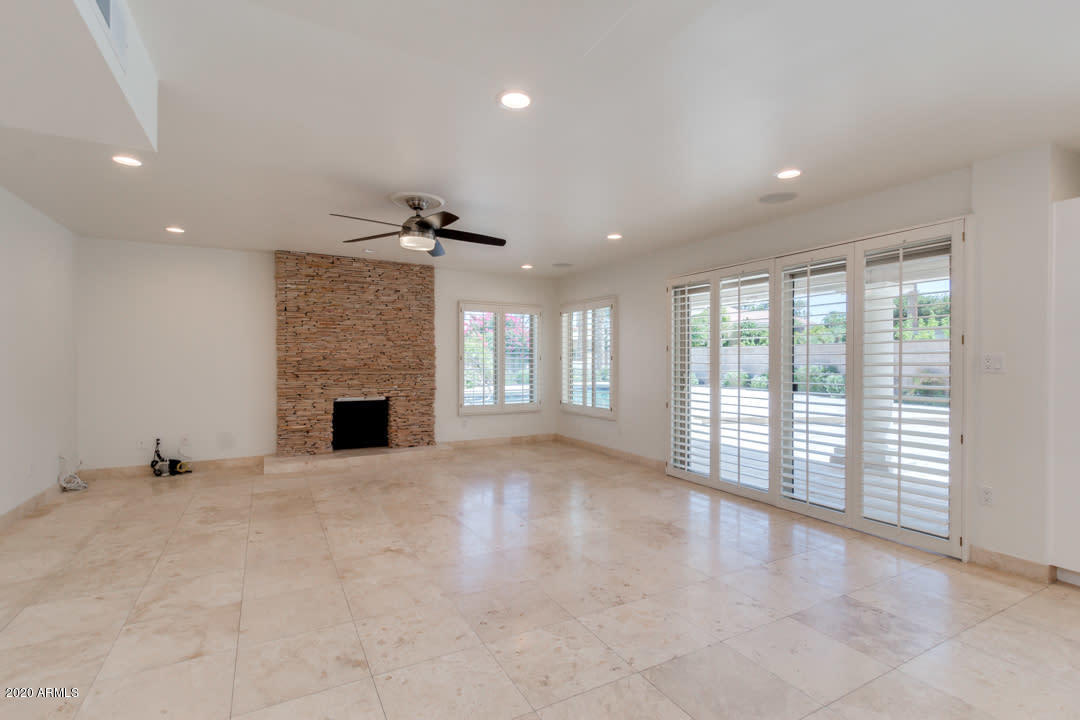 7475 East Raintree Court Scottsdale, AZ 85258 - Photo 3 of 38 an empty room with windows and fireplace