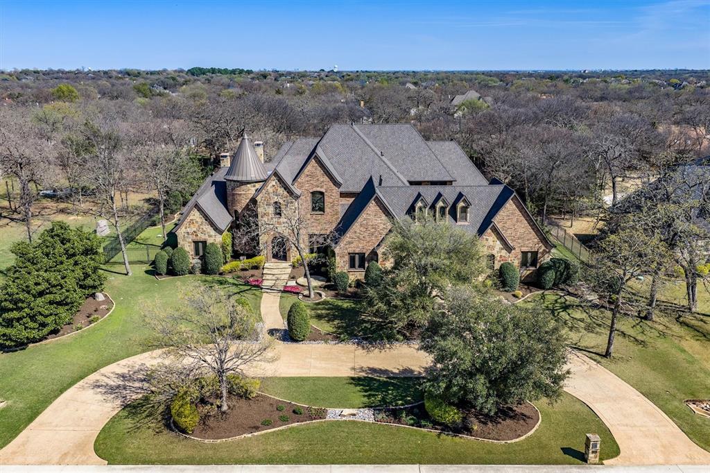 Stunning private estate set on two beautifully treed acres at the end of a quiet cul-de-sac in the sought-after West Oaks community. The grand circular drive and timeless architecture create an unforgettable first impression.