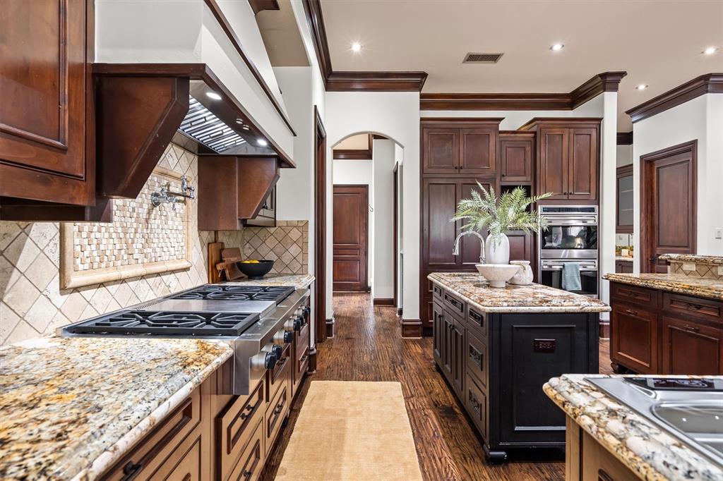 9 Victory Lane Double Oak, TX 75077 - Photo 12 of 40 Thoughtful layout provides excellent flow between cooking, dining, and entertaining areas. A large island and extensive storage make it both functional and beautiful.