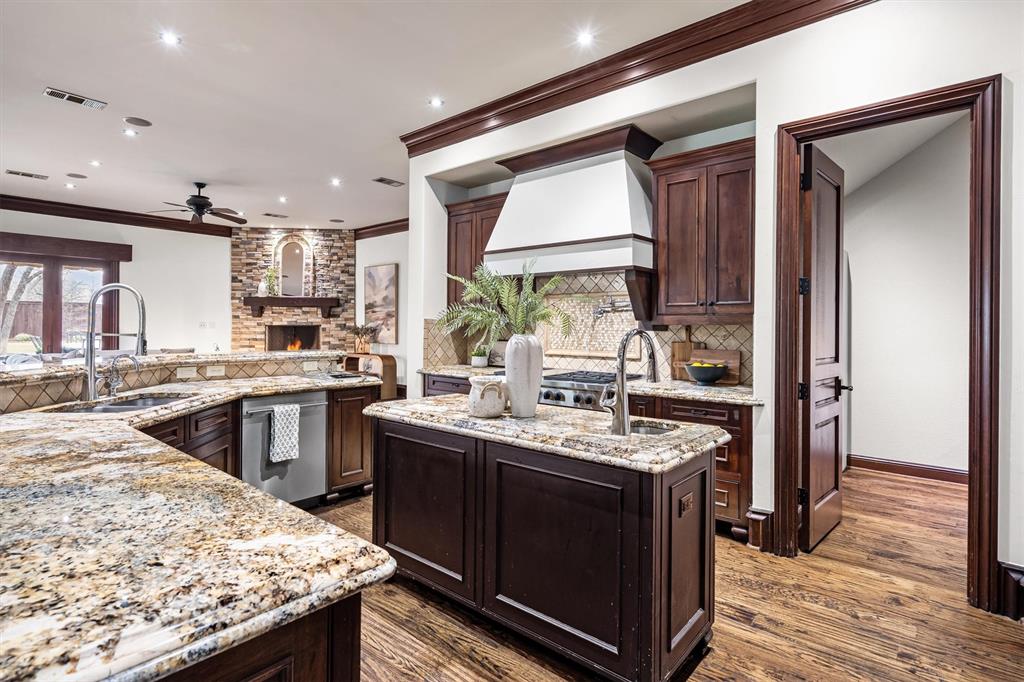 9 Victory Lane Double Oak, TX 75077 - Photo 13 of 40 Expansive with double islands, premium finishes, and ample workspace. Perfect for preparing meals while staying connected to the home’s main living areas.