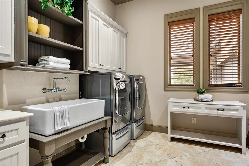 9 Victory Lane Double Oak, TX 75077 - Photo 16 of 40 Spacious laundry room with extensive cabinetry, folding space, and utility sink. Designed to make everyday household tasks efficient and organized.