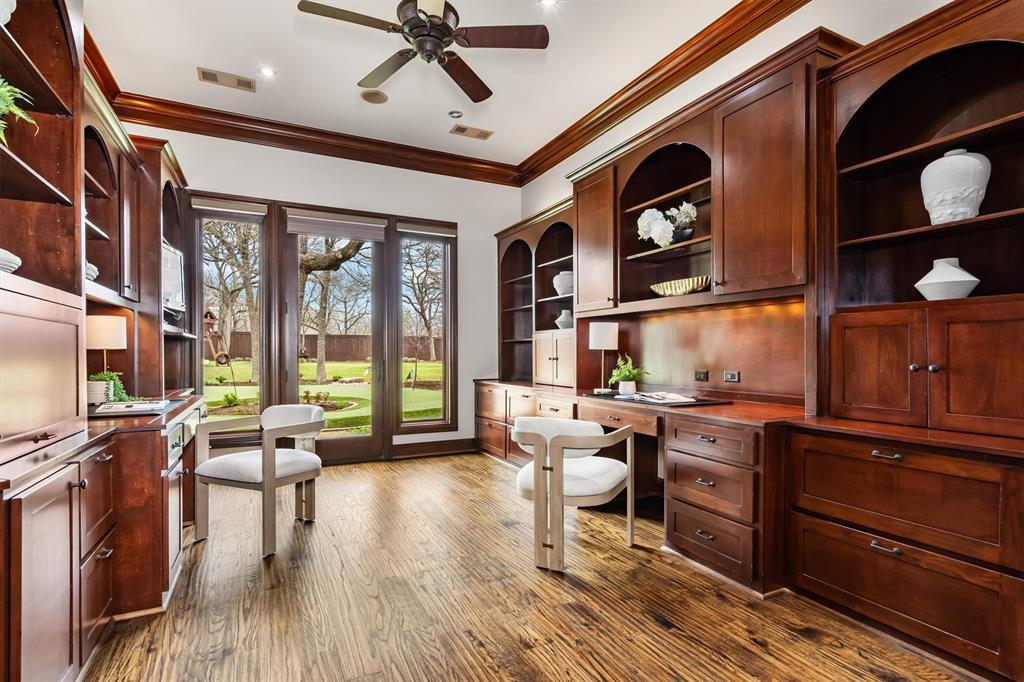 9 Victory Lane Double Oak, TX 75077 - Photo 17 of 40 Private executive office with rich wood built-ins, coffered ceiling, and large windows overlooking the grounds. A beautiful and quiet workspace ideal for working from home.