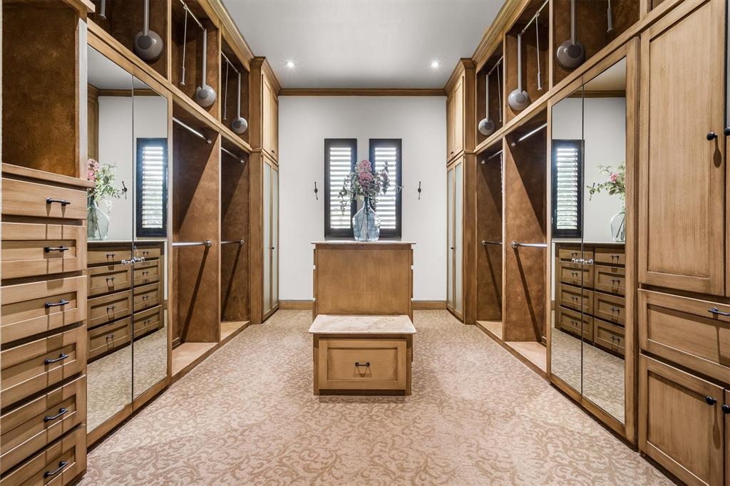 9 Victory Lane Double Oak, TX 75077 - Photo 22 of 40 Expansive custom walk-in closet with built-in cabinetry and organized storage throughout. Designed to provide ample space for wardrobe, accessories, and daily convenience.