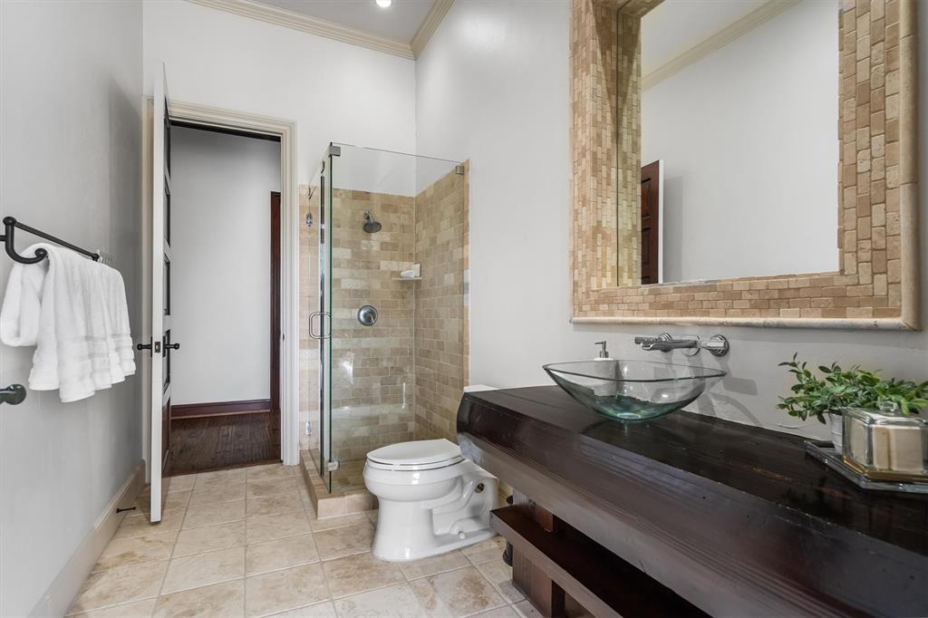 9 Victory Lane Double Oak, TX 75077 - Photo 25 of 40 Elegant secondary bathroom featuring custom cabinetry, stone countertops, and quality finishes. Designed to provide comfort and privacy for family or guests.