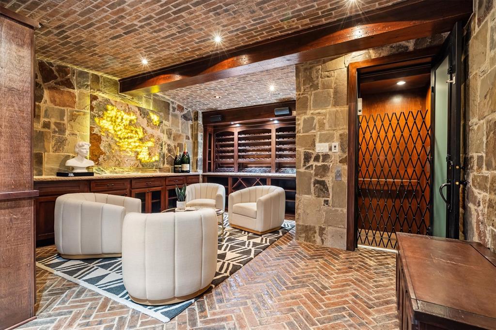 9 Victory Lane Double Oak, TX 75077 - Photo 28 of 40 Temperature-controlled wine cellar with rustic stone accents and intimate seating area. Perfect for collectors and an impressive space for entertaining guests.