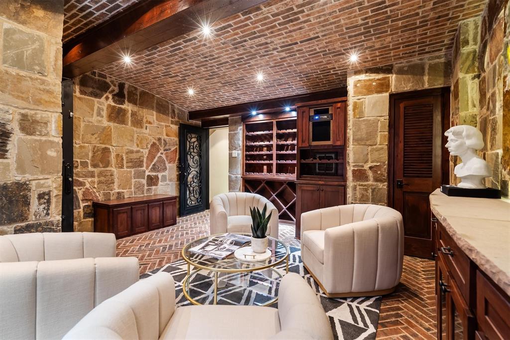 9 Victory Lane Double Oak, TX 75077 - Photo 29 of 40 A tasting area highlights the rich stonework and built-in wine storage. A unique entertaining feature rarely found in residential homes.