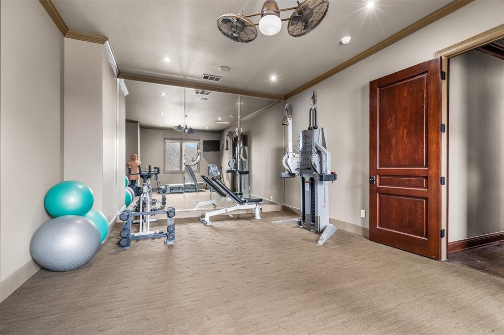 9 Victory Lane Double Oak, TX 75077 - Photo 33 of 40 Dedicated home gym with ample space for equipment and training. A bright and motivating environment that makes it easy to maintain an active lifestyle.