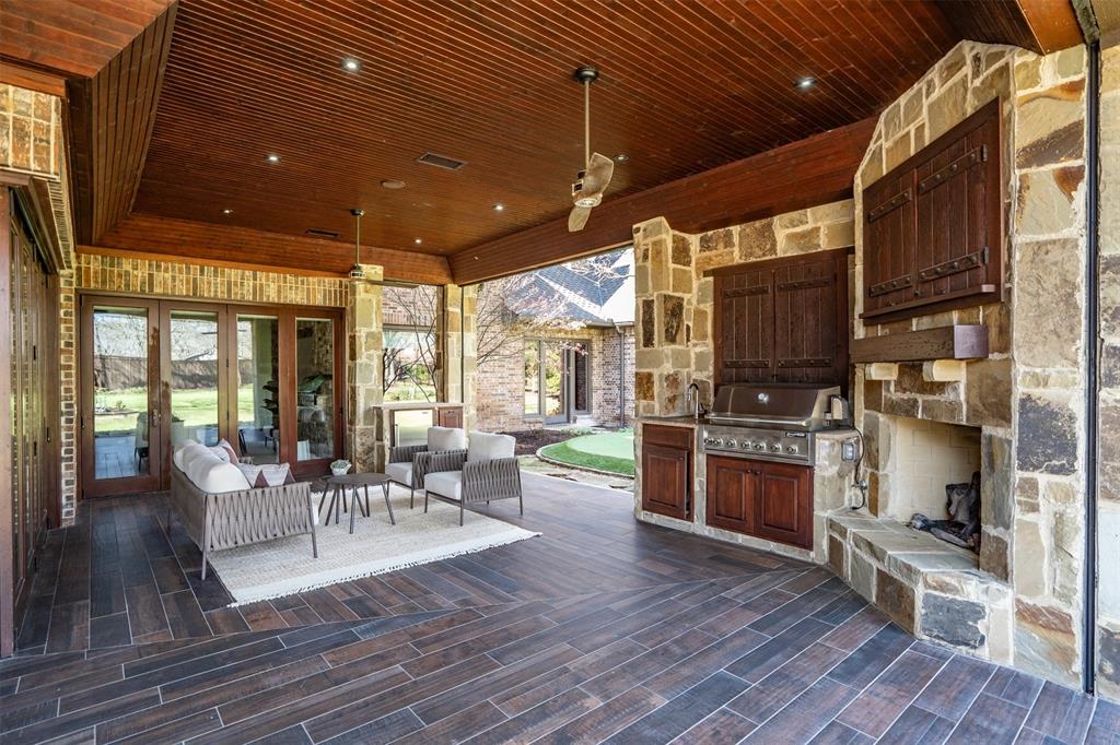 9 Victory Lane Double Oak, TX 75077 - Photo 35 of 40 Outdoor kitchen and entertaining space with built-in grill, bar seating, and generous counter space. Designed for effortless outdoor dining and year-round gatherings.