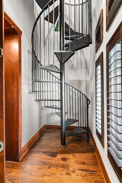 9 Victory Lane Double Oak, TX 75077 - Photo 5 of 40 Elegant spiral staircase with custom iron railing creates a dramatic architectural statement.