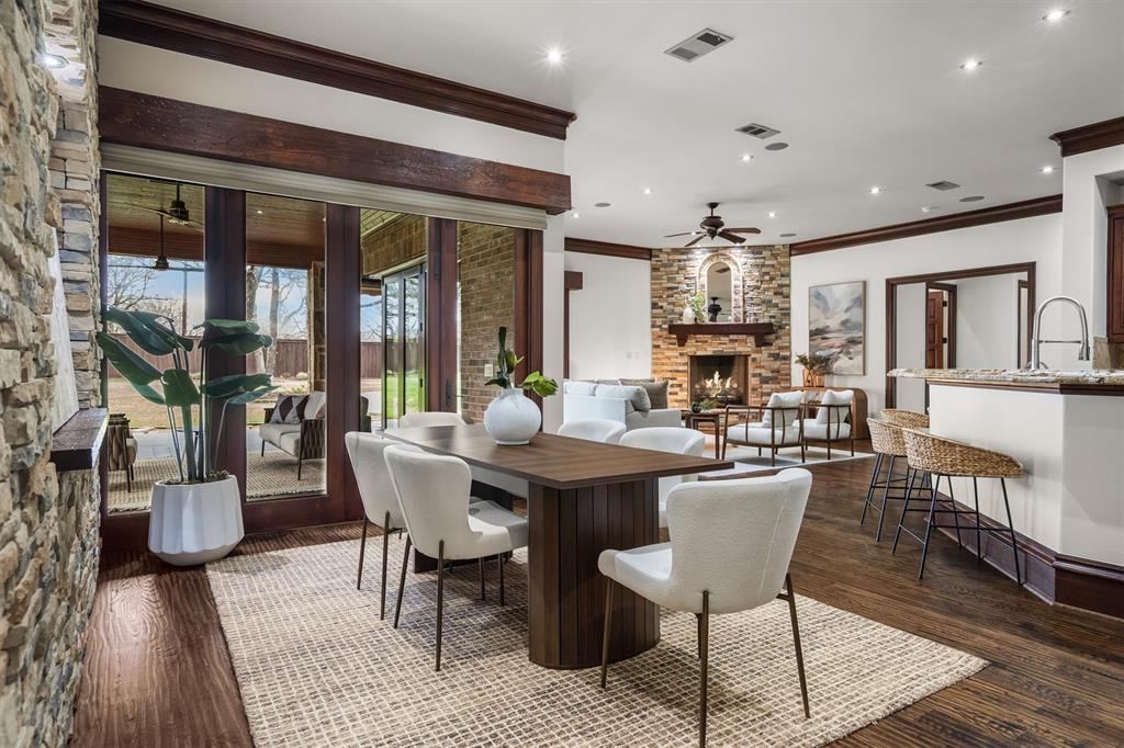 9 Victory Lane Double Oak, TX 75077 - Photo 7 of 40 The main living area features soaring ceilings, rich wood beams, and walls of windows overlooking the backyard. Nano doors open fully to the outdoor patio, blending indoor and outdoor living beautifully.