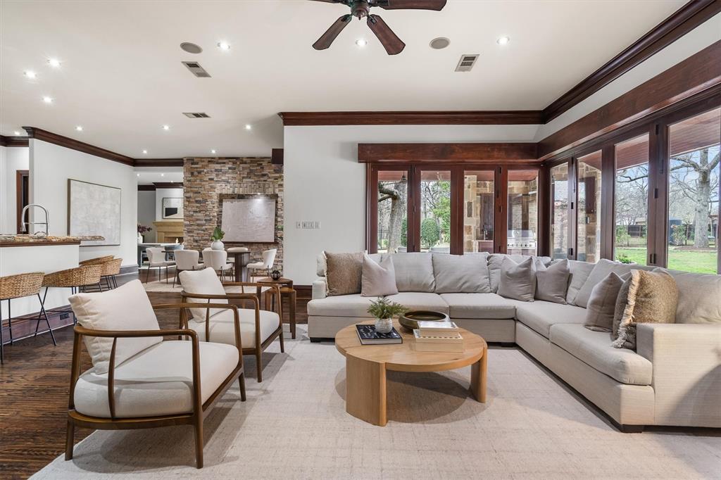 9 Victory Lane Double Oak, TX 75077 - Photo 10 of 40 Provides flexibility for everyday living, game day gatherings, or casual entertaining. Expansive windows showcase views of the pool and surrounding trees.