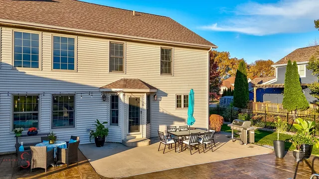 a view of backyard of house with outdoor seating