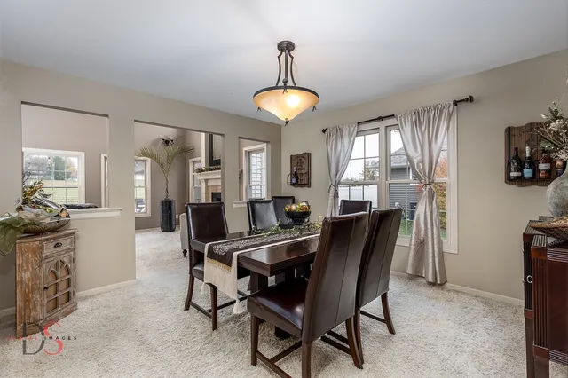 a view of a dining room with furniture and chandelier