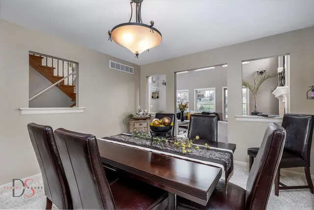 a dining room with furniture and chandelier