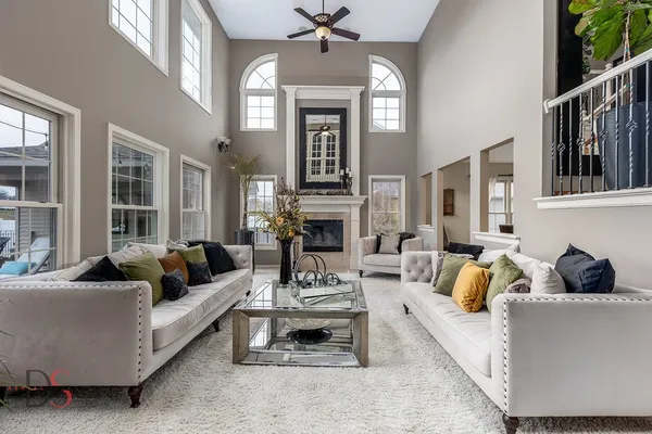 a living room with furniture fireplace and rug