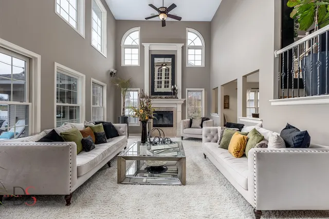 a living room with furniture fireplace and rug