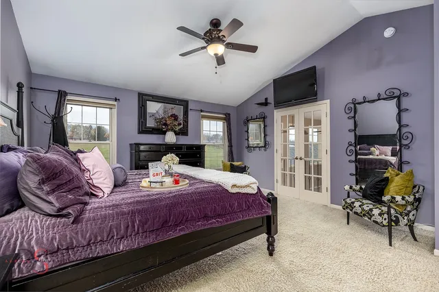 a bedroom with a bed dresser and a flat screen tv