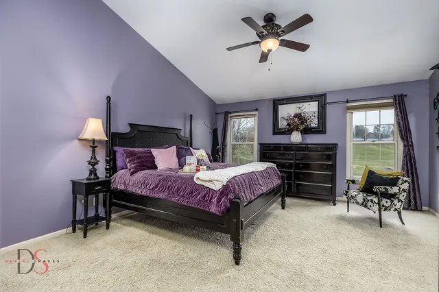 a bedroom with a bed dresser and a chair