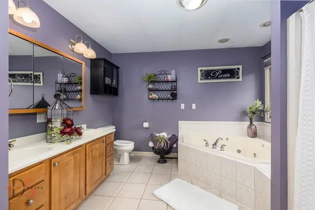 a bathroom with a sink mirror and toilet