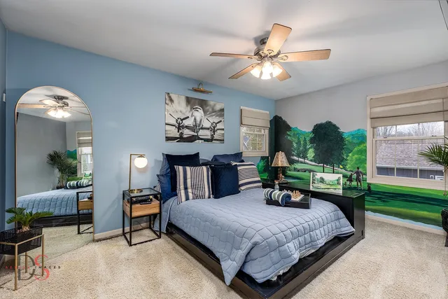 a bedroom with a bed a chandelier and a bookshelf