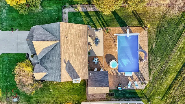 an aerial view of a house with a swimming pool