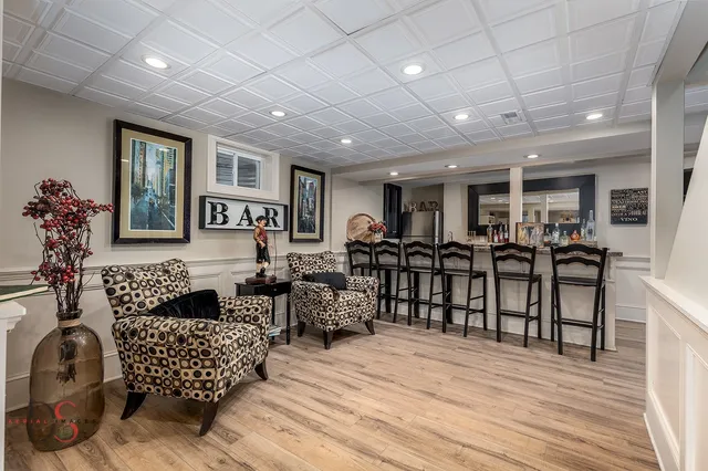 a living room with furniture a wooden floor and potted plant