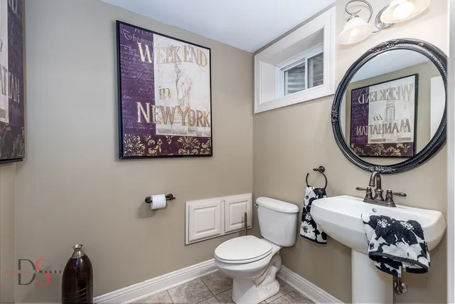 a bathroom with a toilet a sink and a mirror