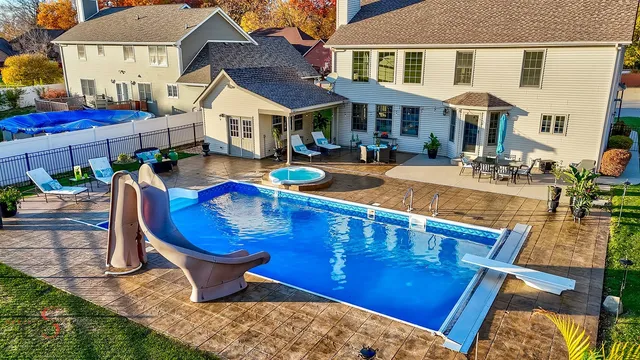a view of a house with pool porch and sitting area