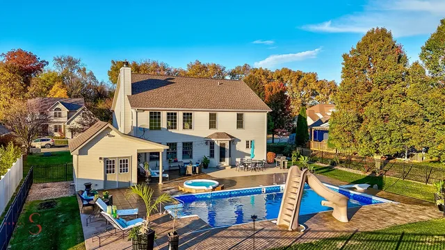 a aerial view of a house with swimming pool and sitting area