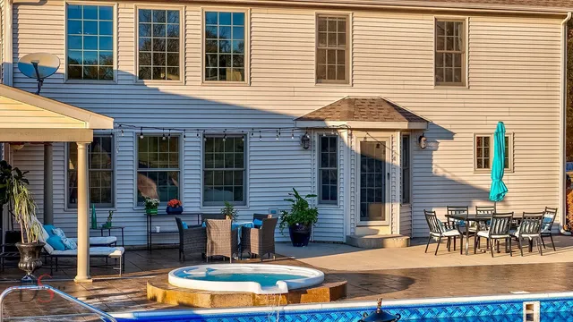 a view of a house with swimming pool and sitting area