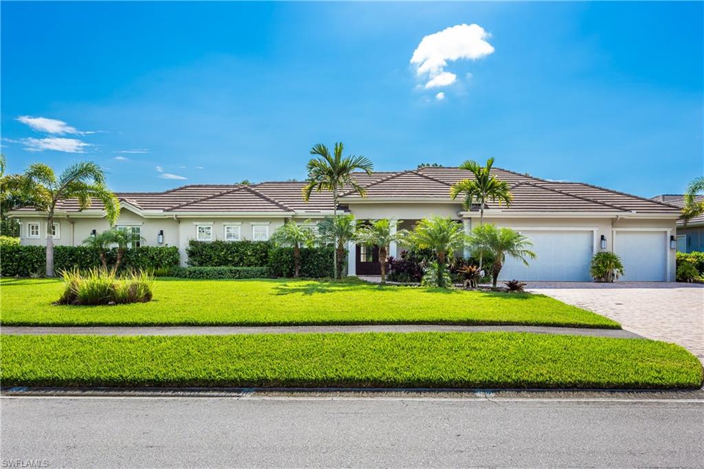 a view of a house with a big yard and potted plants