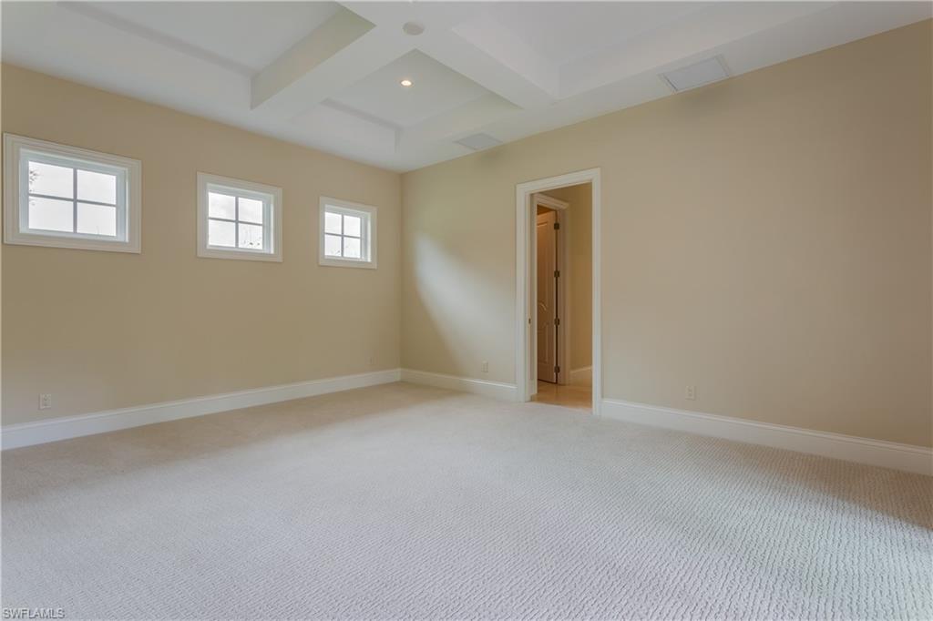 6578 Ridgewood Drive Naples, FL 34108 - Photo 14 of 35 an empty room with windows