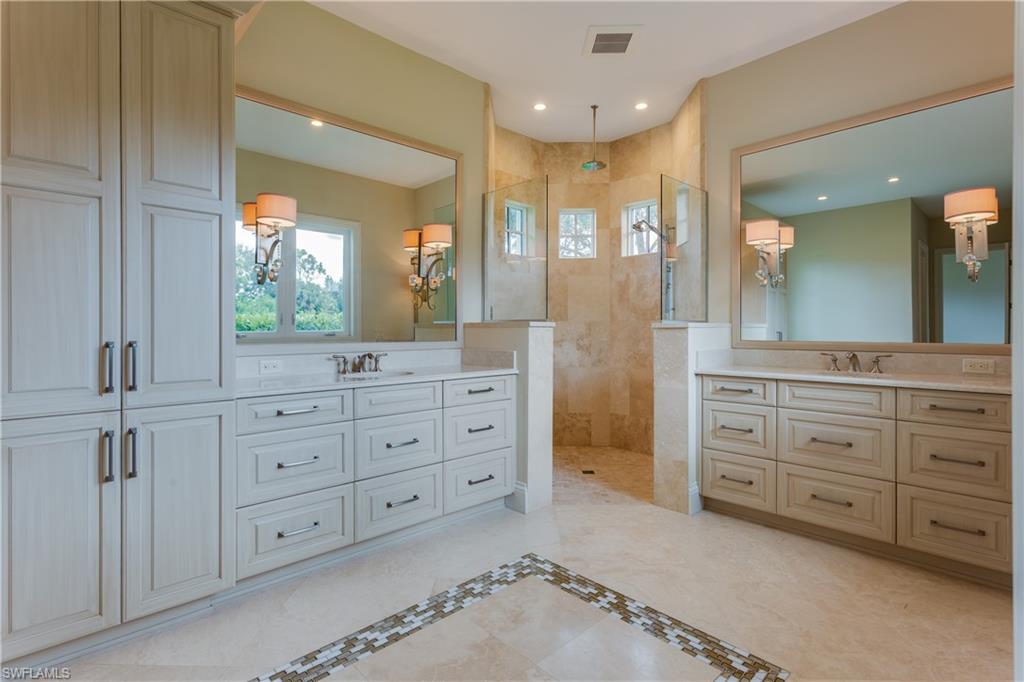 6578 Ridgewood Drive Naples, FL 34108 - Photo 18 of 35 wooden bathroom with a granite countertop sink mirror and a