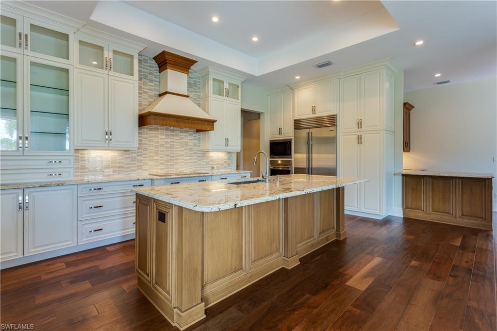 6578 Ridgewood Drive Naples, FL 34108 - Photo 2 of 35 a kitchen with stainless steel appliances granite countertop a sink stove and refrigerator