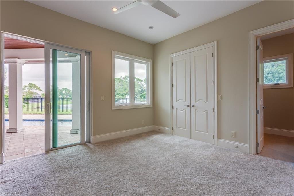 6578 Ridgewood Drive Naples, FL 34108 - Photo 21 of 35 a view of an empty room with a window