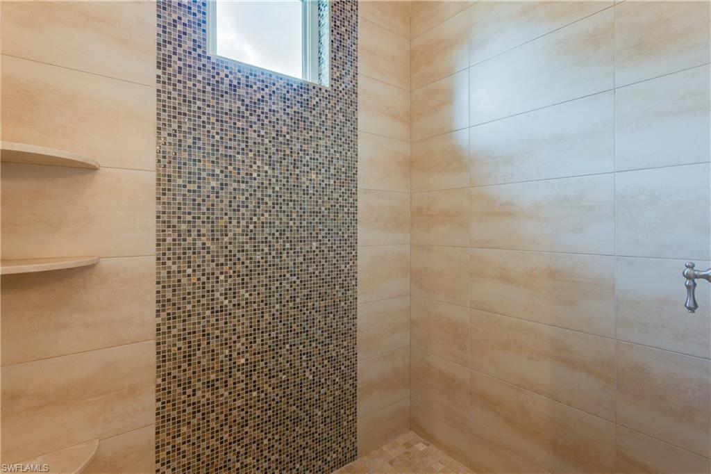 6578 Ridgewood Drive Naples, FL 34108 - Photo 23 of 35 a bathroom with a shower