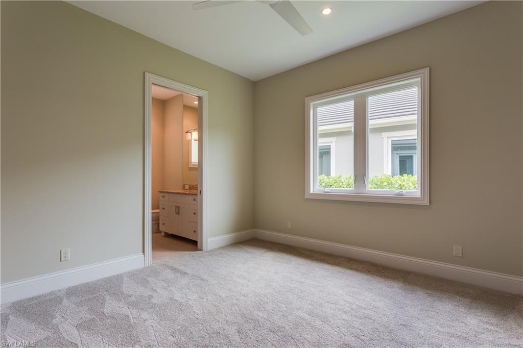 6578 Ridgewood Drive Naples, FL 34108 - Photo 24 of 35 an empty room with windows and closet