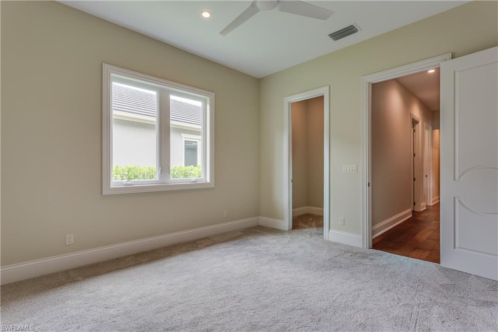 6578 Ridgewood Drive Naples, FL 34108 - Photo 25 of 35 an empty room with windows and closet