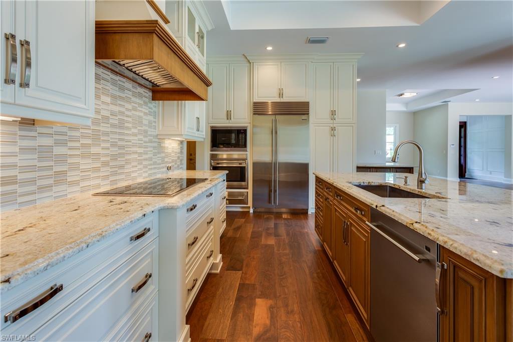 6578 Ridgewood Drive Naples, FL 34108 - Photo 3 of 35 a large kitchen with stainless steel appliances kitchen island granite countertop a large counter top and sink