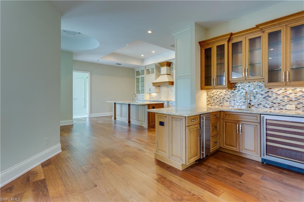 6578 Ridgewood Drive Naples, FL 34108 - Photo 5 of 35 a kitchen with stainless steel appliances granite countertop a stove and a sink