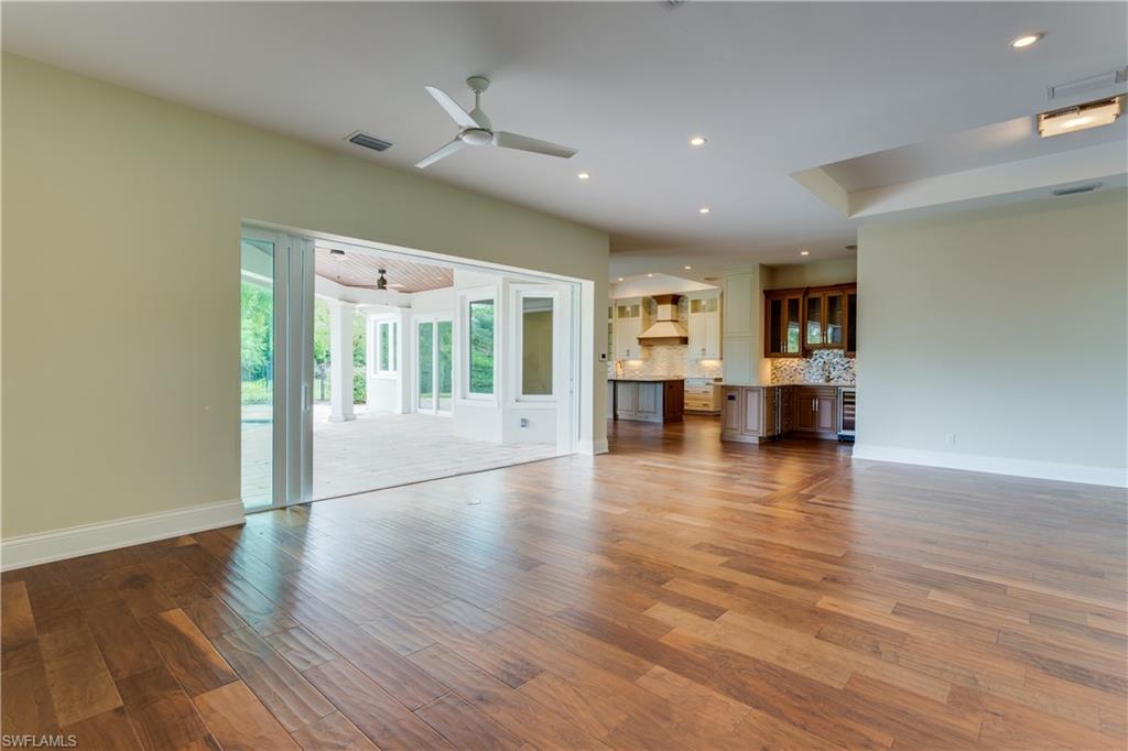 6578 Ridgewood Drive Naples, FL 34108 - Photo 6 of 35 a view of kitchen with furniture and wooden floor
