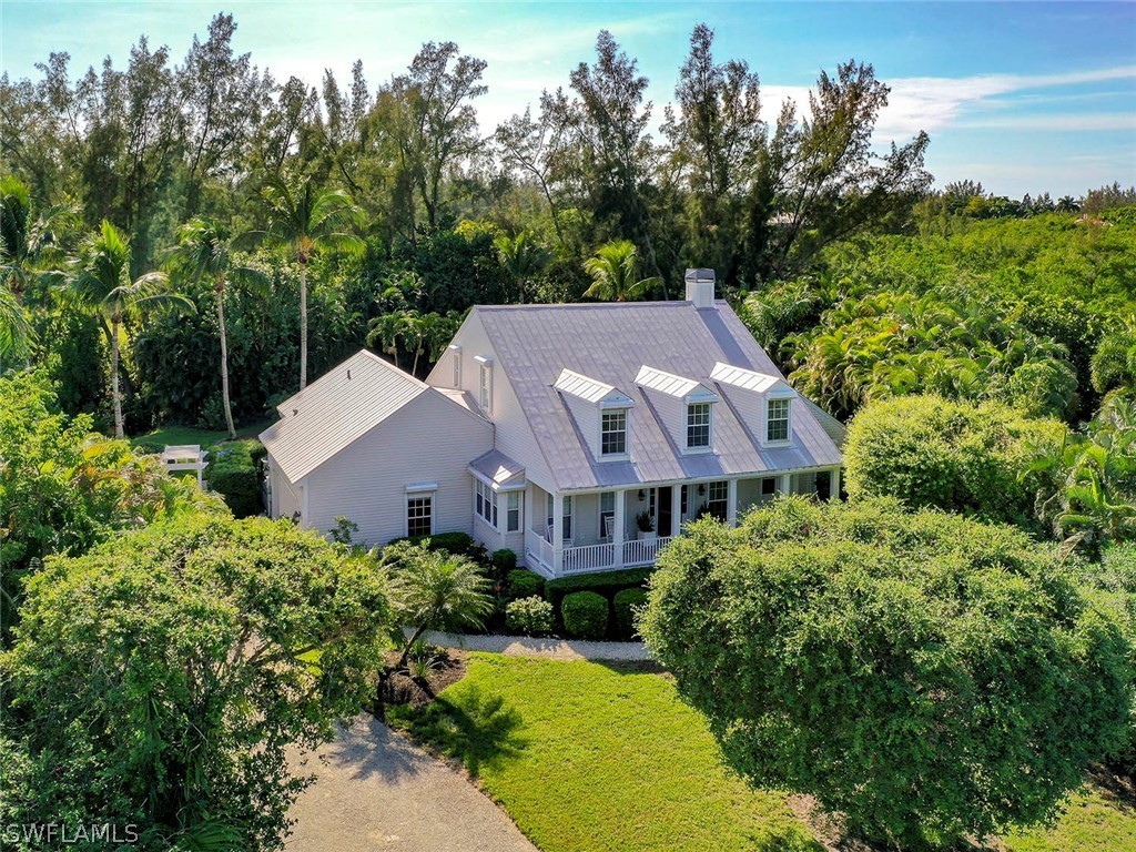 1358 Sand Castle Road Sanibel, FL 33957 - Photo 1 of 26 an aerial view of a house with yard and green space