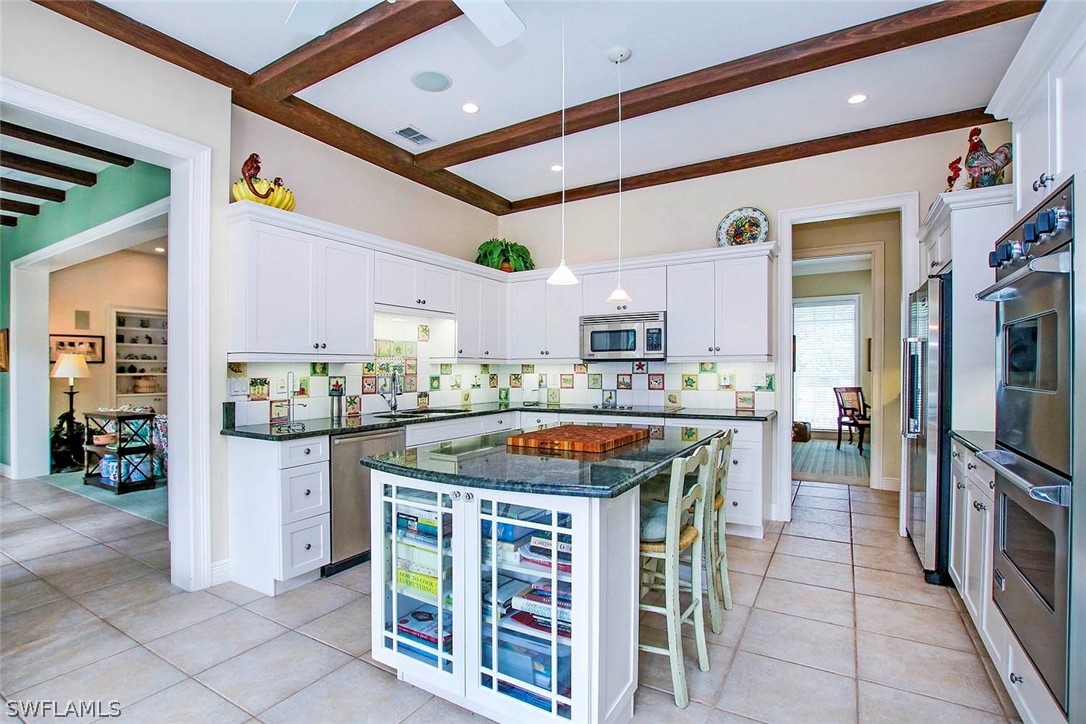 1358 Sand Castle Road Sanibel, FL 33957 - Photo 11 of 26 a kitchen with stainless steel appliances granite countertop a stove and a sink