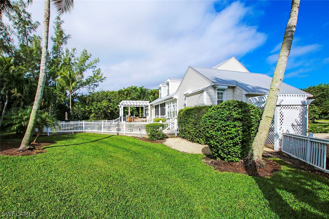 1358 Sand Castle Road Sanibel, FL 33957 - Photo 2 of 26 a view of a house with a yard porch and sitting area