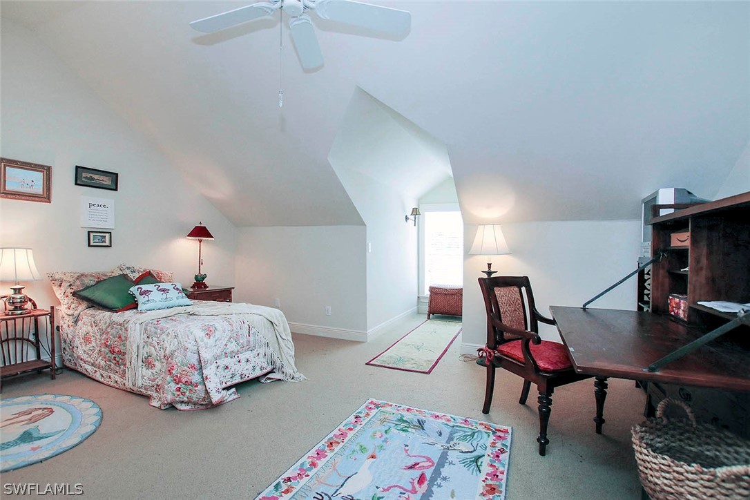 1358 Sand Castle Road Sanibel, FL 33957 - Photo 22 of 26 a bedroom with bed and a lamp on dresser