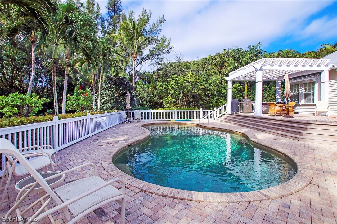 1358 Sand Castle Road Sanibel, FL 33957 - Photo 3 of 26 a view of a swimming pool with a patio