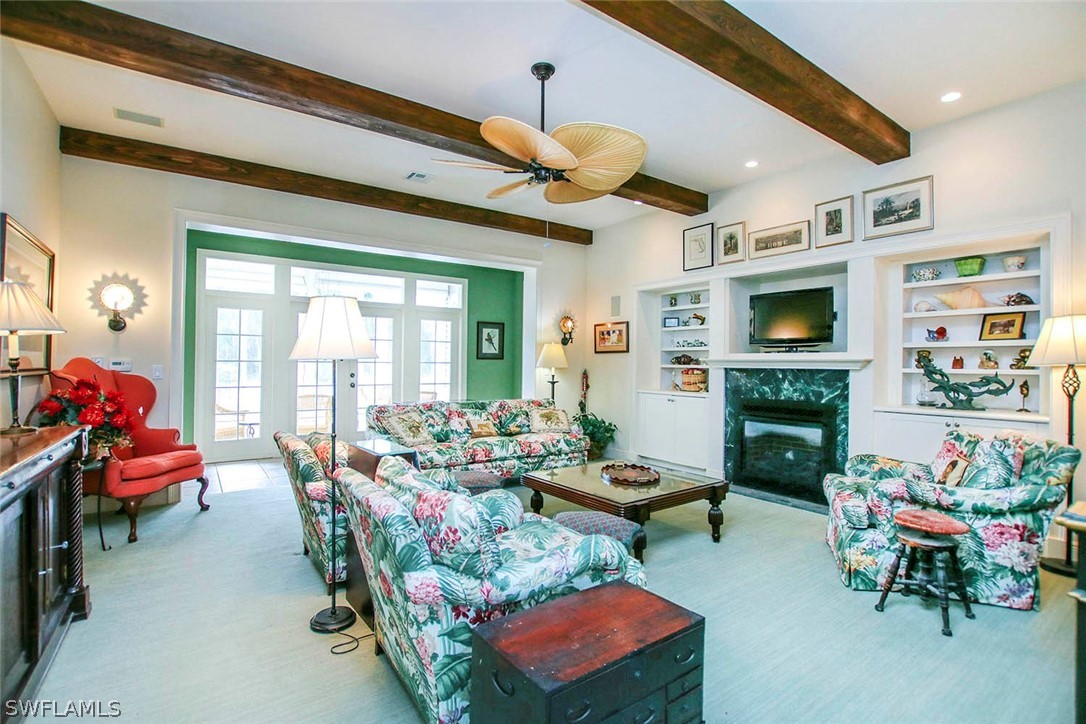 1358 Sand Castle Road Sanibel, FL 33957 - Photo 6 of 26 a living room with furniture fireplace and flat screen tv