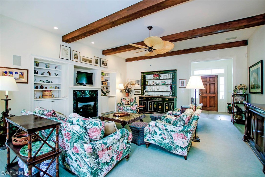 1358 Sand Castle Road Sanibel, FL 33957 - Photo 7 of 26 a living room with fireplace furniture and a flat screen tv