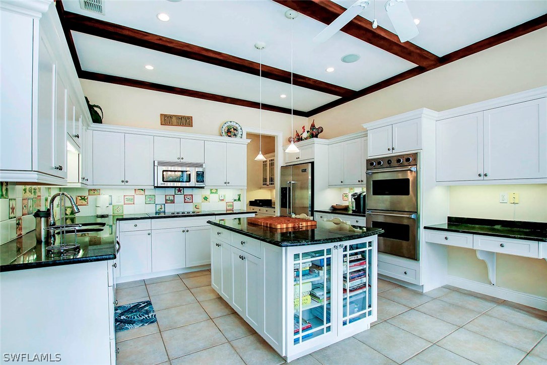 1358 Sand Castle Road Sanibel, FL 33957 - Photo 10 of 26 a kitchen with stainless steel appliances granite countertop a stove and a sink
